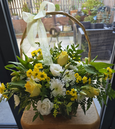 Sunshine basket - Lovely sunshine basket enough to brighten anyone's day in a lovely yellow mix of colours. Flowers and colours may vary depending on availability,  but your florist will produce a lovely bright basket for you.